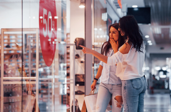 Feeling excited. Two young women have a shopping day together in the supermarket.